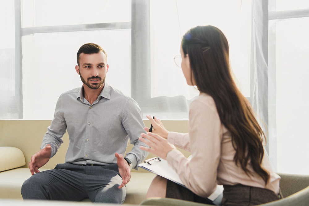 A therapist explaining to a patient about opioid treatment programs