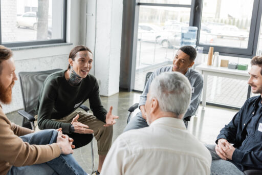 Group members listen attentively during a psychoeducational session on drug abuse and recovery.