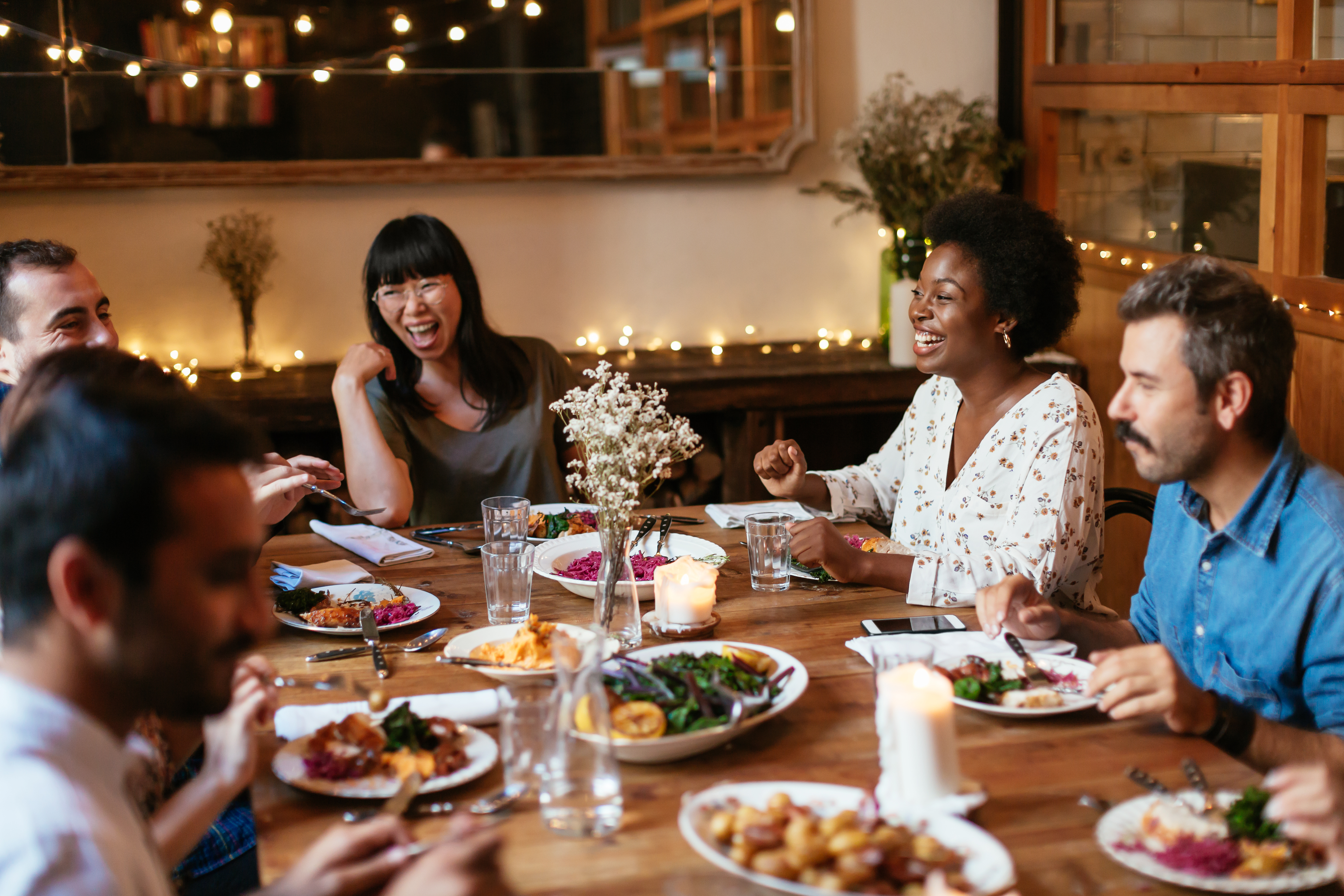 Featured image on how to stay sober while recovering from substance use disorder - Friends dining indoors